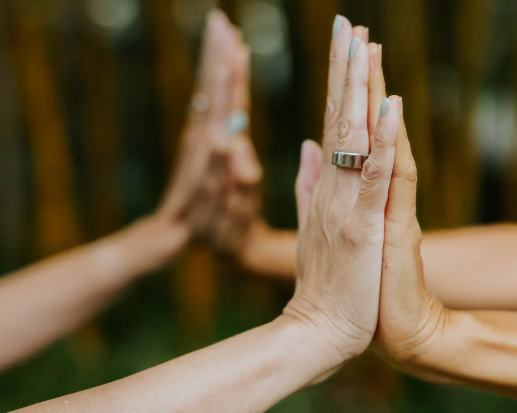 Two palms touching another pair of palms