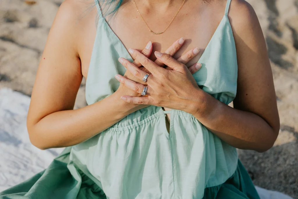 An image of a woman with both of her hands on her heart